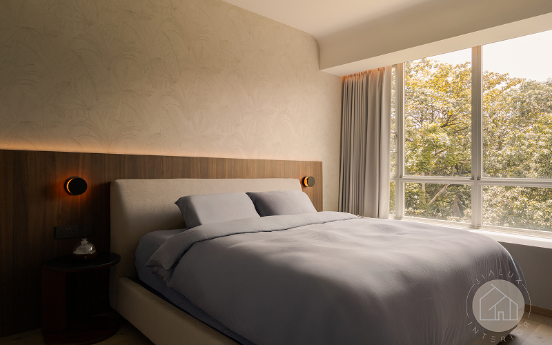 Contemporary bedroom design with warm lighting and large windows.