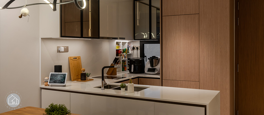 Modern kitchen with white island and sleek black cabinetry.