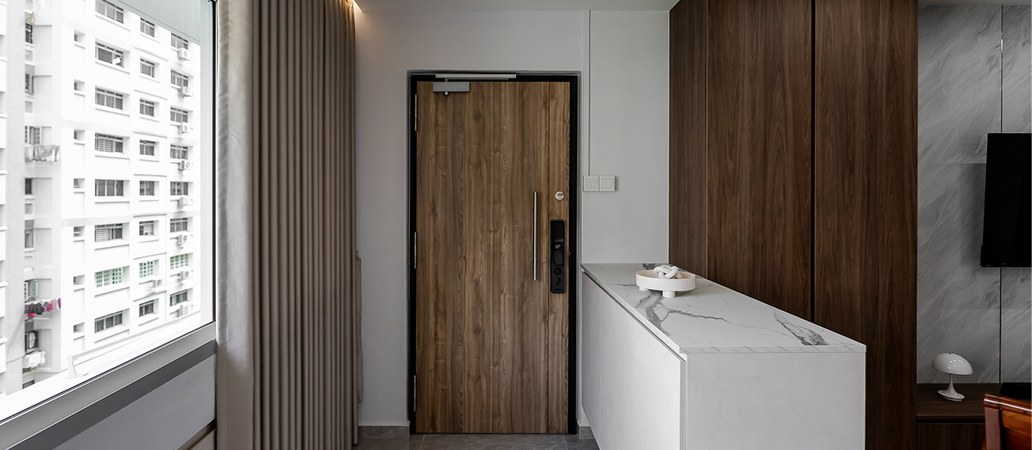 Home entryway featuring durable wood-laminate door and marble counter.